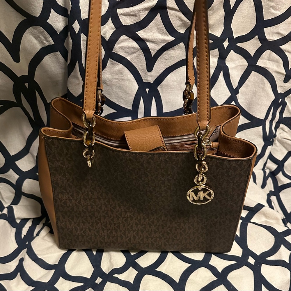 {47} Michael Kors Signature Sofia Tote.